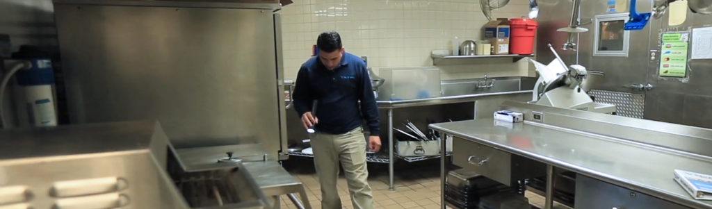 employee checking commercial kitchen